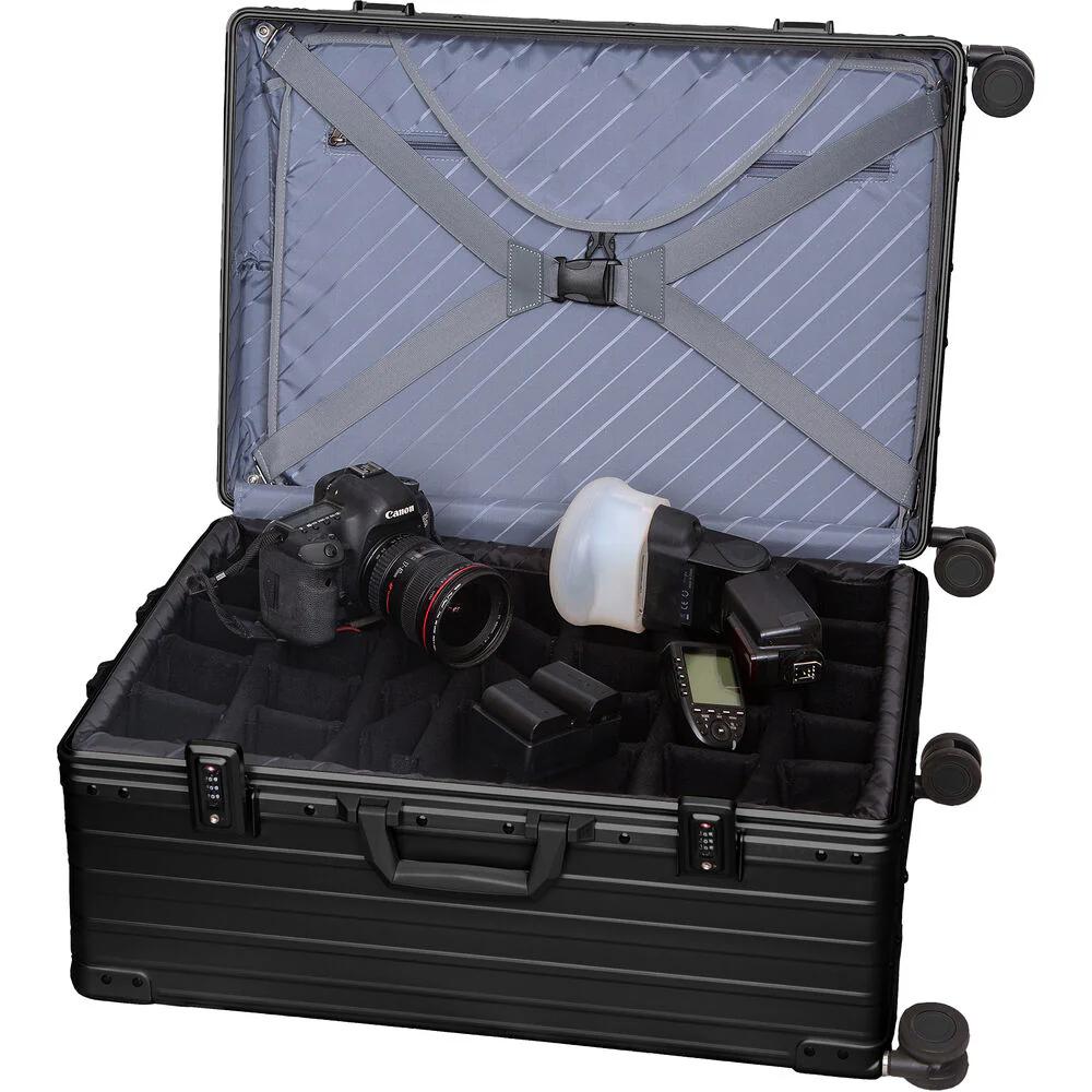 Black ALEON 30" aluminum camera case open, showing padded insert with adjustable dividers, camera, and accessories.