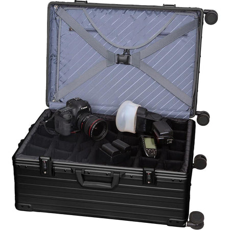 Black ALEON 30" aluminum camera case open, showing padded insert with adjustable dividers, camera, and accessories.